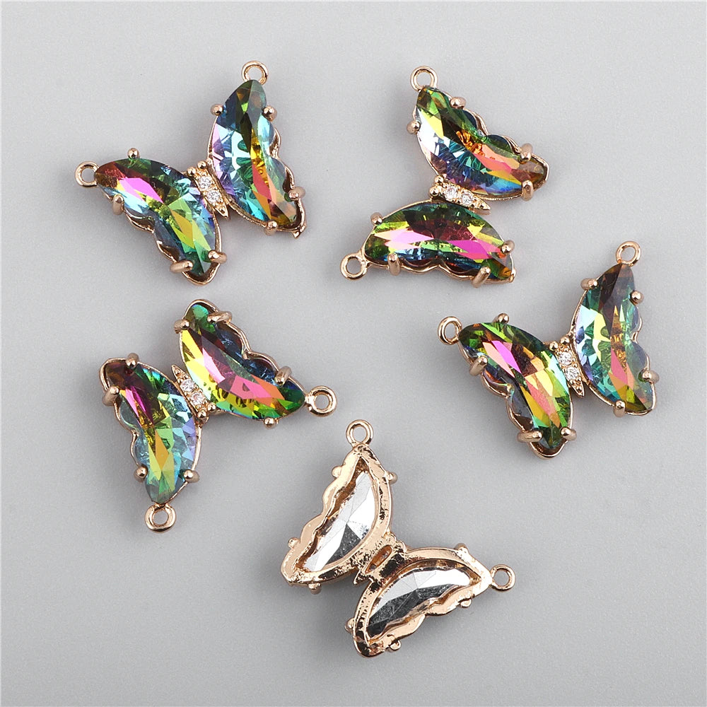 Several iridescent crystal butterfly charm beads are displayed against a gray background.