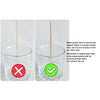 A glass candle holder with a wooden wick inserted, demonstrating the difference between cotton and wood wicks.