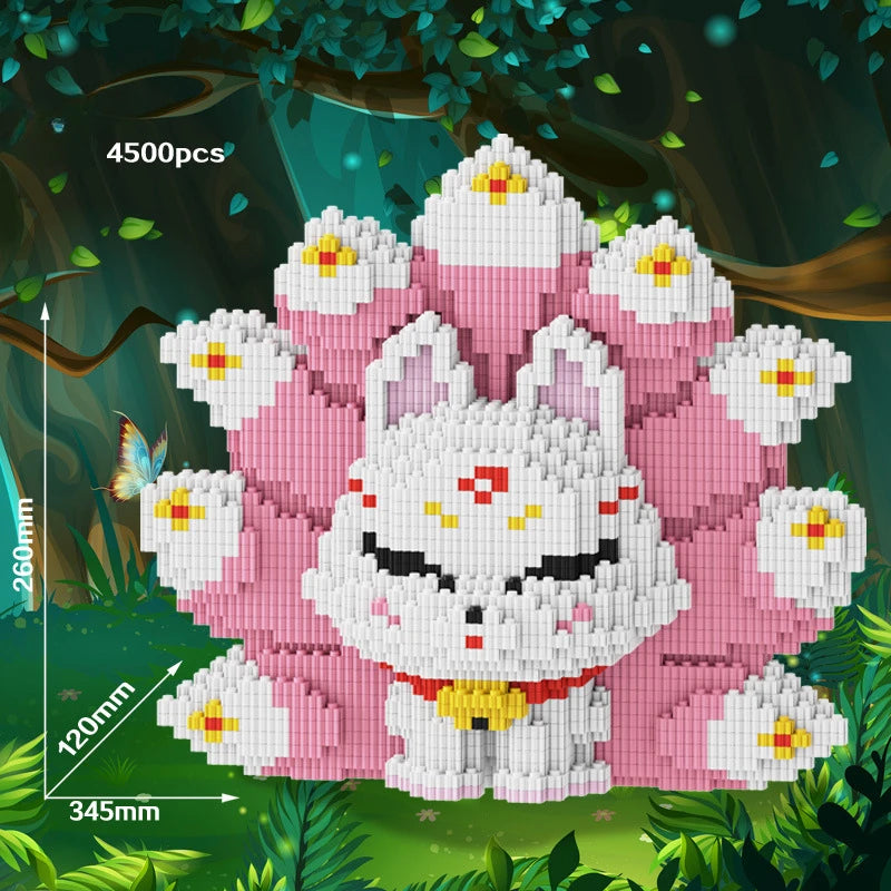 A white and pink nine-tailed fox building block set is displayed in a forest setting surrounded by green foliage.