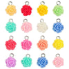 A collection of colorful, handcrafted flower charms in shades of yellow, pink, and green for jewelry making.