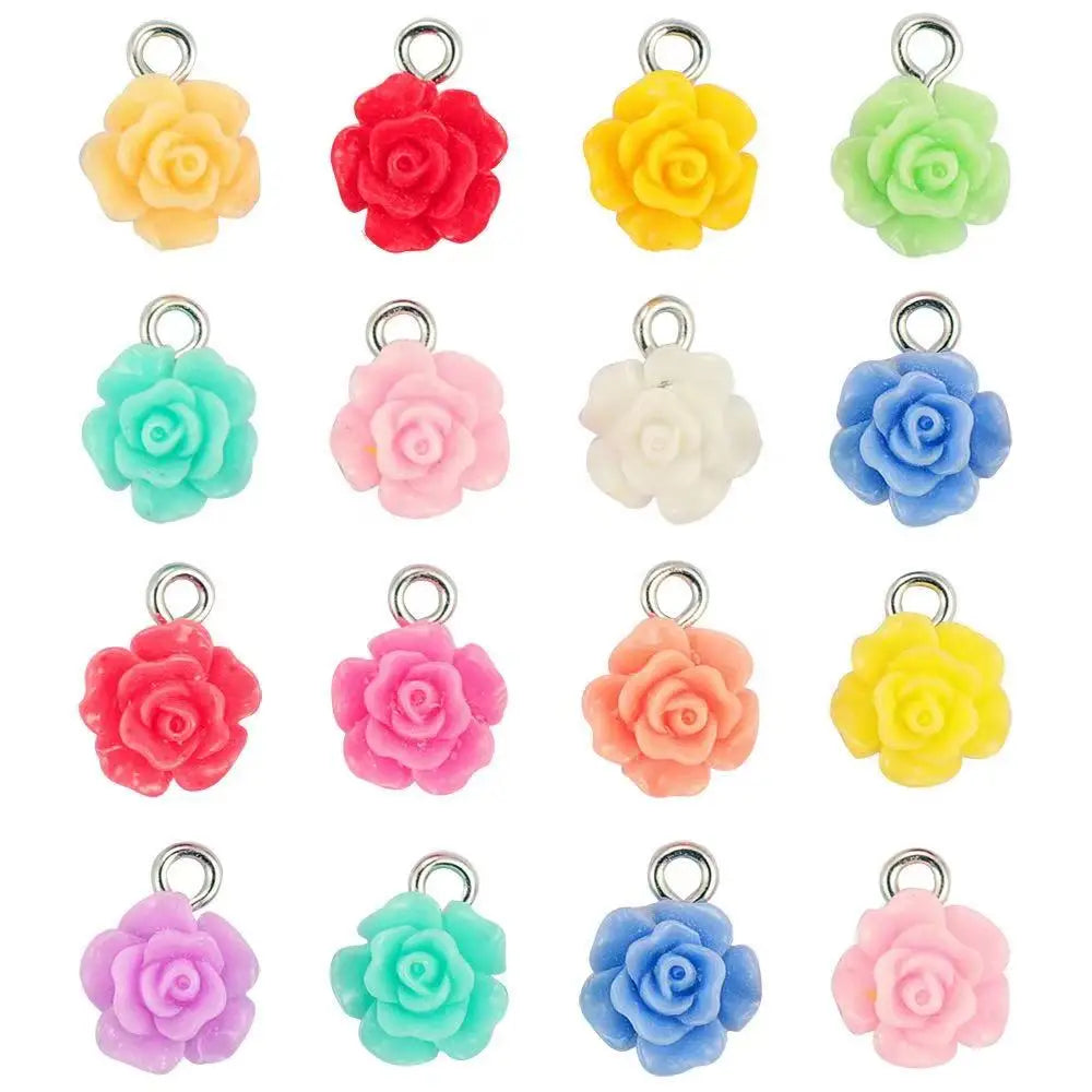 A collection of colorful, handcrafted flower charms in shades of yellow, pink, and green for jewelry making.
