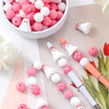 A set of 25 silicone beads in pink and white, including ghost shapes, for jewelry and crafting.