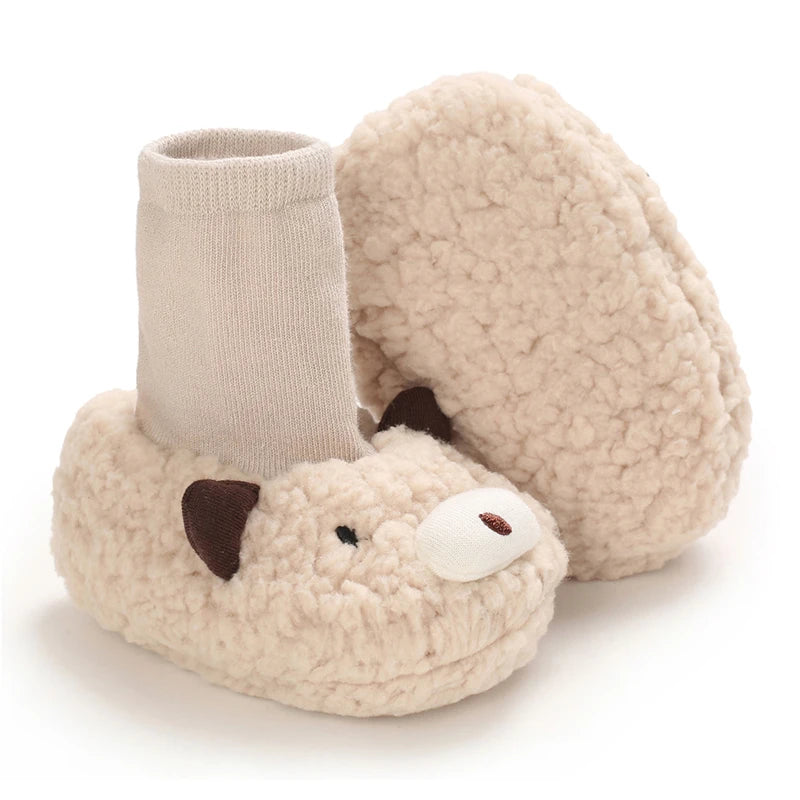 A pair of light beige, fluffy cartoon animal baby booties with a knitted cuff and a soft sole.