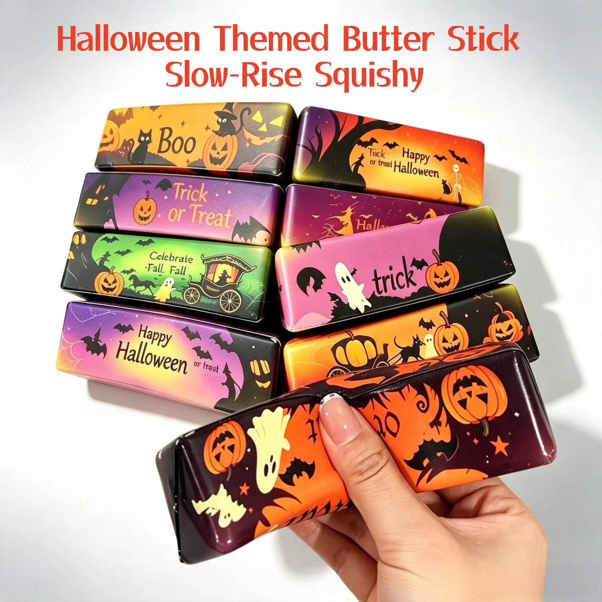 A hand holds a Halloween themed butter stick slow-rise squishy toy in various colors and designs.