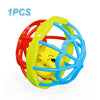 A colorful soft baby grasping ball rattle with a bell, featuring red, yellow, and blue rings.
