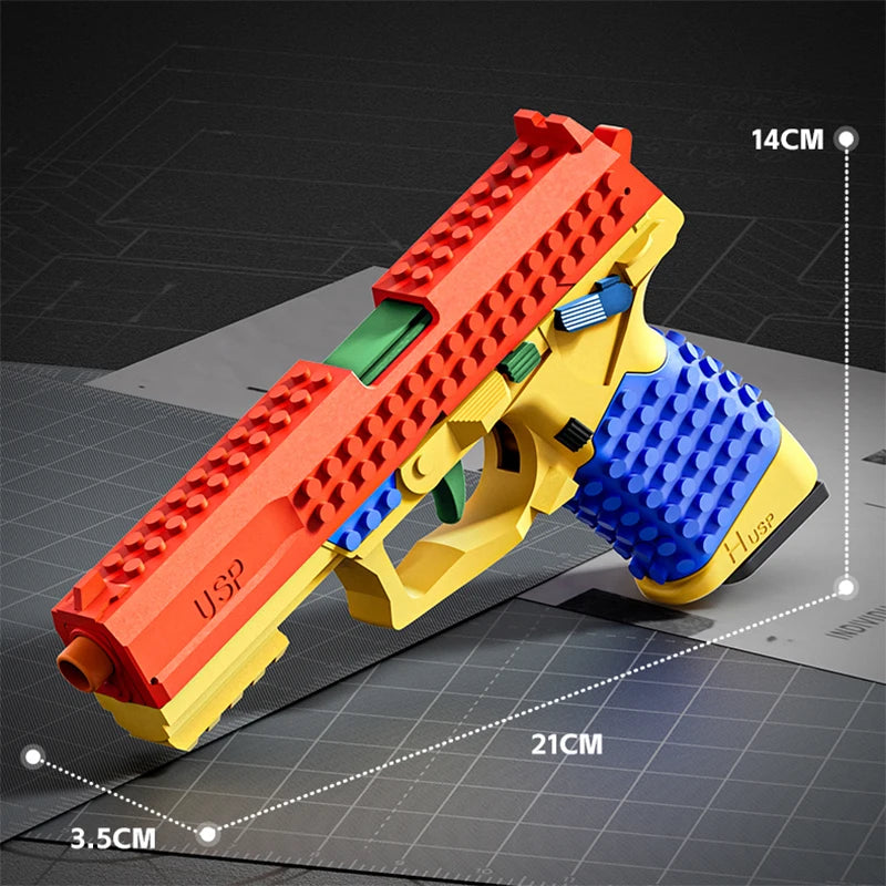 A yellow soft-fire gel blaster pistol toy gun with an orange barrel and blue grip, shown on a grid background.