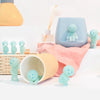 A collection of light blue and green glow-in-the-dark mini fitness figurines displayed on a white surface.