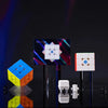 A magnetic speed cube is displayed next to a colorful cube and small white components on a dark surface.