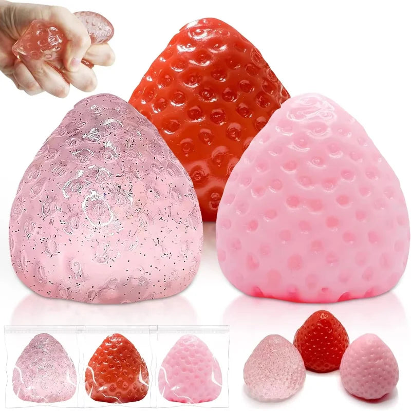 Various pink and red strawberry squishy fidget toys shown in different shapes and textures