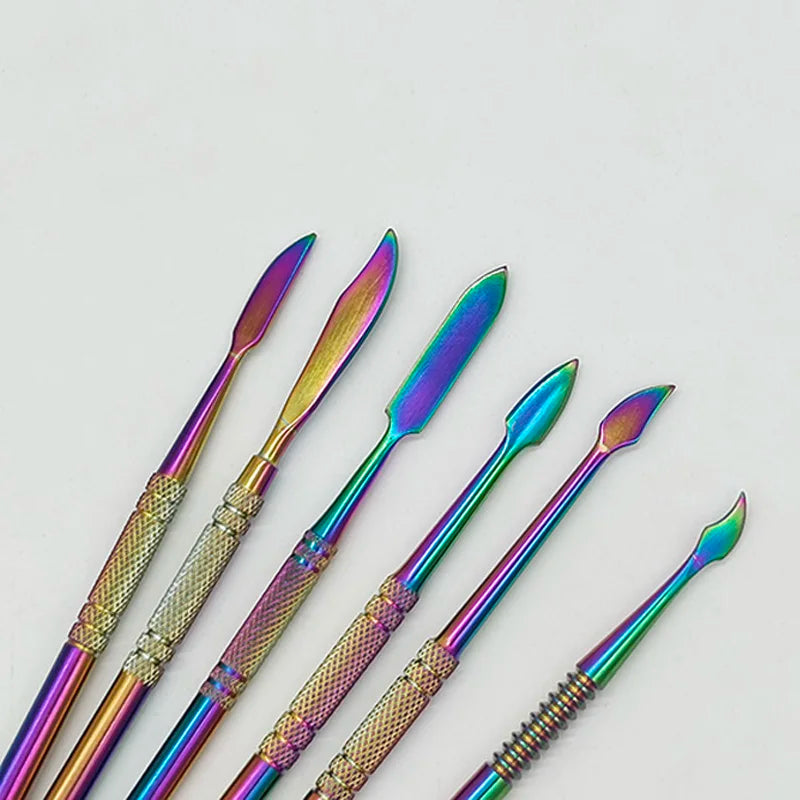 A set of ten colorful stainless steel clay sculpting tools with iridescent finishes arranged diagonally.