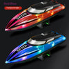 A red and blue high-speed RC boat with transparent LED lights shown in profile view.