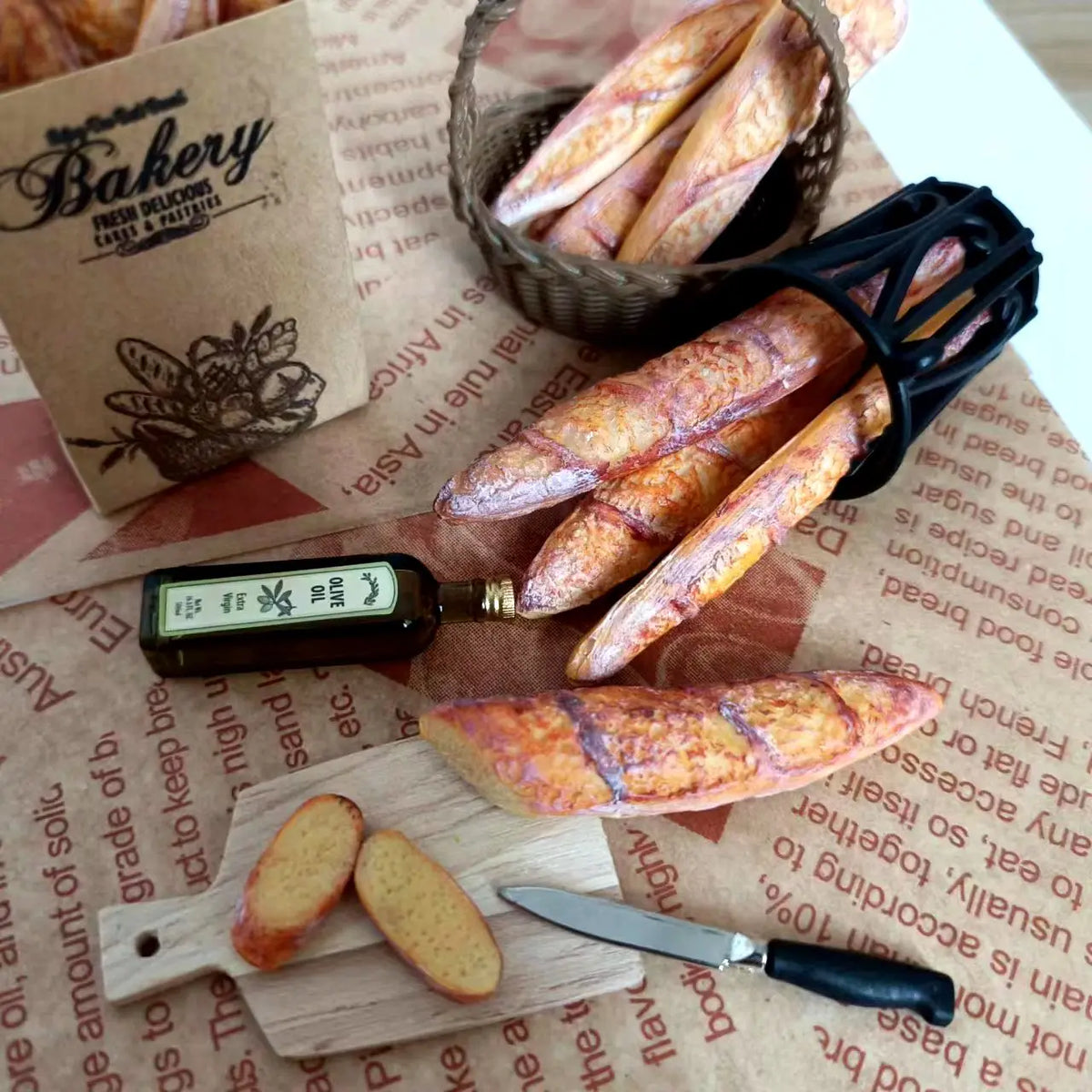 Handmade 1:6 scale miniature baguette for dollhouse kitchens displayed on brown paper.