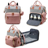 A pink and gray premium diaper backpack with a built-in changing station and storage pockets.