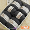 A box of six balls of grey wool yarn for knitting, labeled as 1 pack equals 500g.
