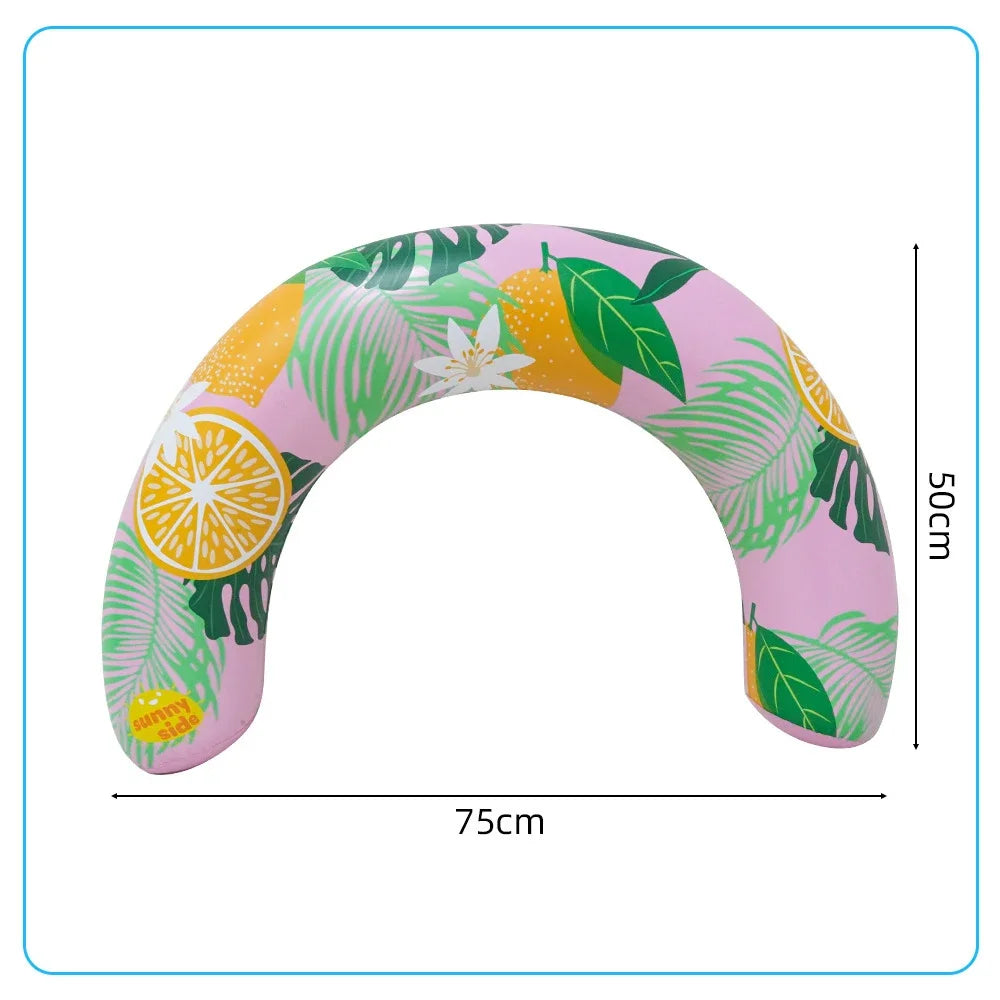 Pink inflatable U-shaped swim ring with a tropical leaf and citrus pattern.