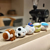 A row of colorful sport ball plush keychain charms featuring various animals and sports themes.