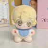 A light blonde chibi plush keychain of a character with large eyes and a blue patterned collar.