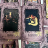 A collection of oracle cards featuring dark and light imagery with titles like Shadow and Compassion.