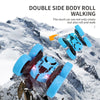 A blue double-side body roll walking stunt car is shown navigating a snowy mountain landscape.