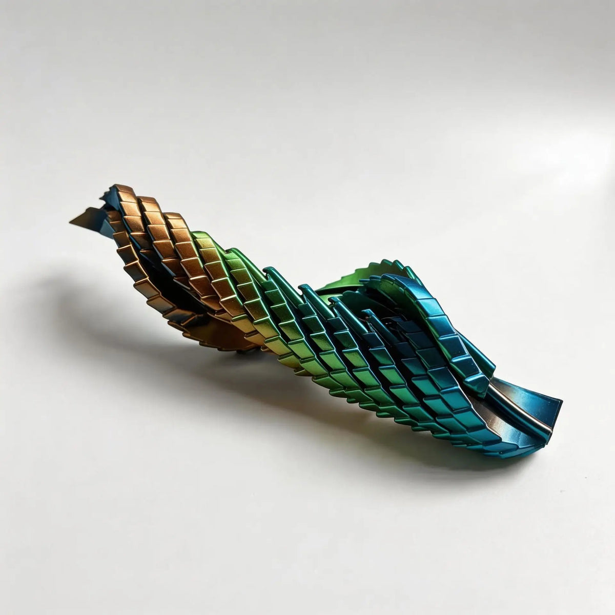 A 3D printed transformable dragon egg fidget toy made of metallic green and bronze plastic, shown in a diagonal view.