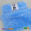 A bright blue faux fur yarn product featuring a label and a swatch of the fluffy material.