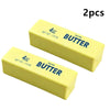 Two yellow salted butter sticks, 4oz each, used as a squishy fidget toy.