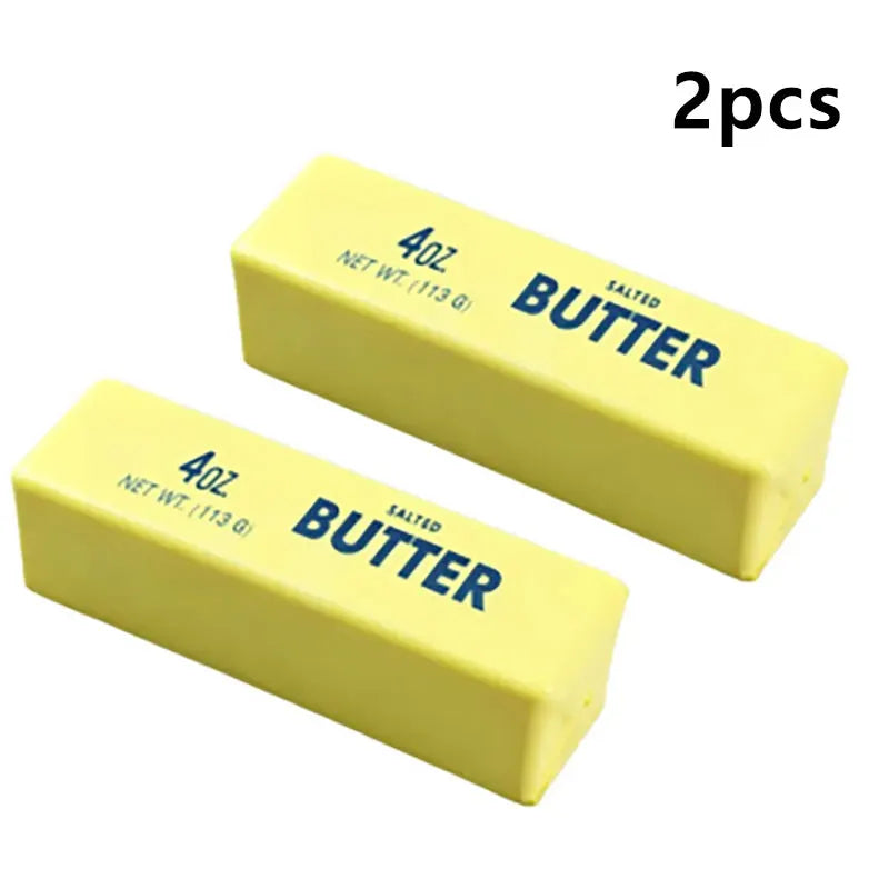 Two yellow salted butter sticks, 4oz each, used as a squishy fidget toy.