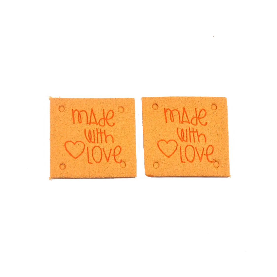 Two orange embossed leather labels with the text Made with Love stamped on them