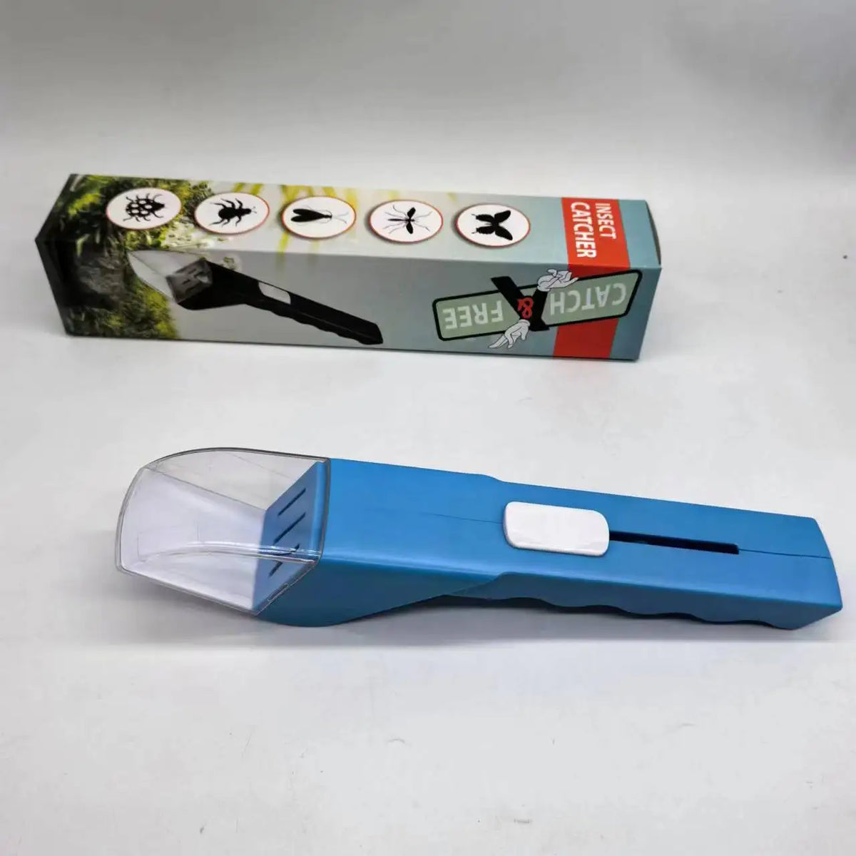 A blue handheld insect catcher with a clear magnifying lens is shown next to its packaging.