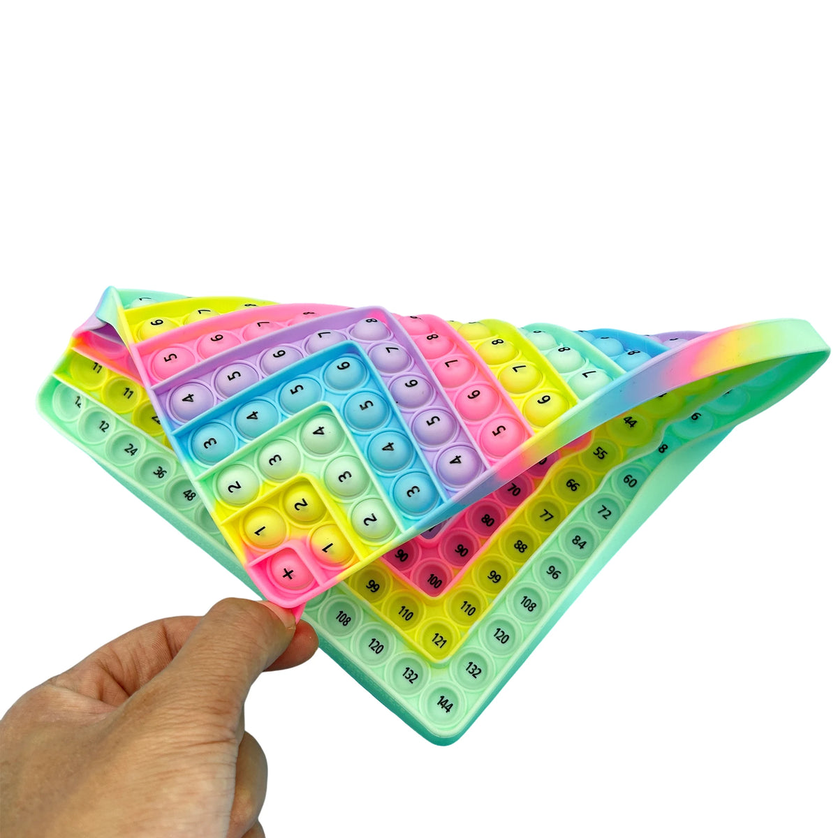 A hand holds a colorful fidget toy featuring numbered tiles for multiplication and addition.