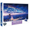 A box for a 1000-piece jigsaw puzzle depicting a train flying through a starry night sky over a landscape.