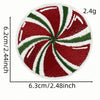 A circular iron-on patch featuring a red and green swirl pattern resembling a festive cartoon character.