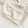 A cream colored toddler fleece-lined winter coat with a half-zip collar shown flat lay.