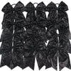A pack of twelve black glitter sequin pigtail bows for girls with elastic hair ties.