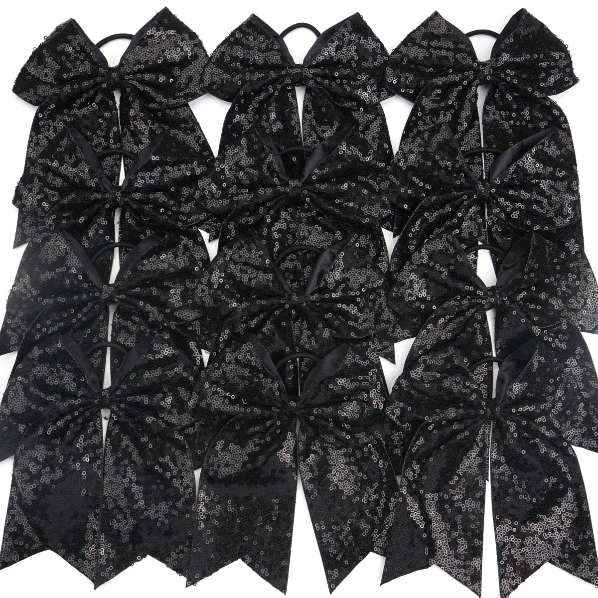 A pack of twelve black glitter sequin pigtail bows for girls with elastic hair ties.