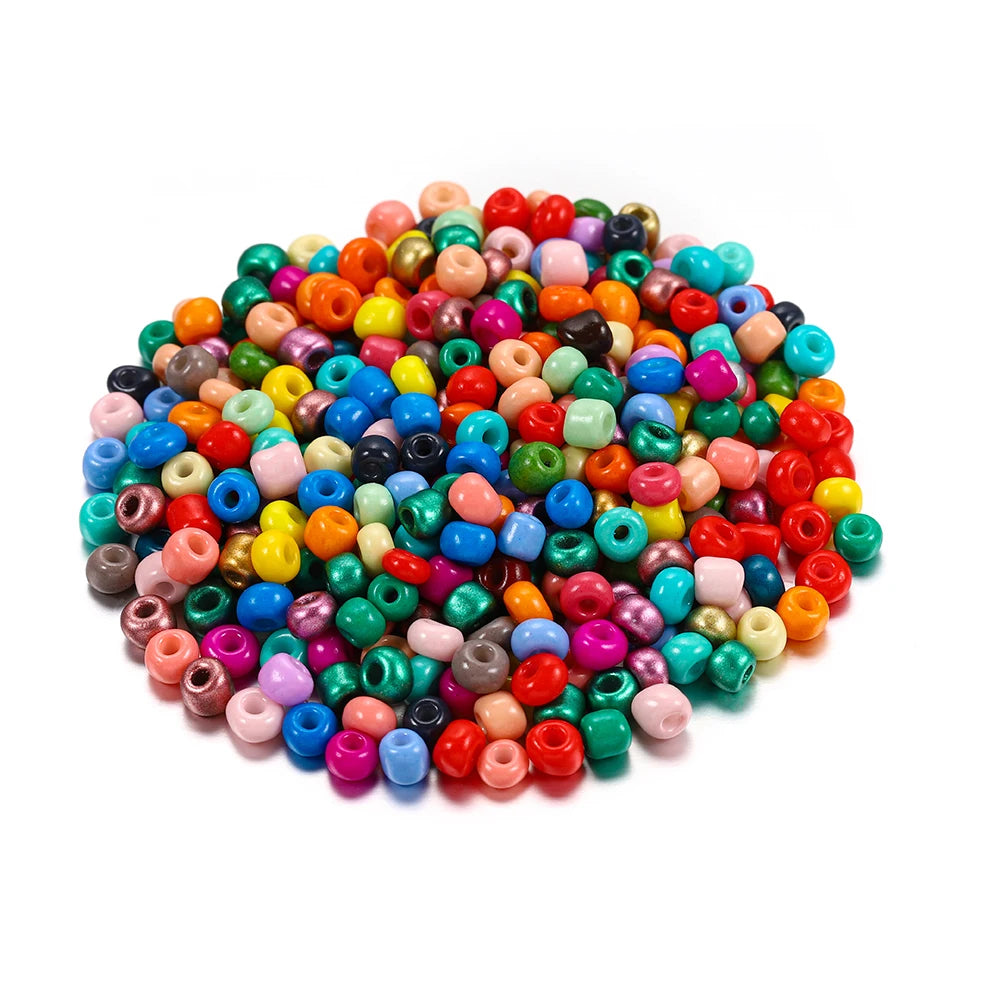 A pile of colorful round glass seed beads in various shades of blue, green, pink, and orange for jewelry making