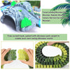 A set of green and yellow dinosaur park carpet pieces used to create a curved racing track for toy cars.