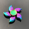 A rainbow metal fidget spinner featuring iridescent, teardrop-shaped pieces and a central disc.