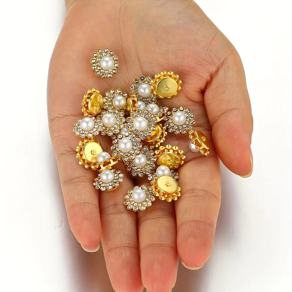 A hand holds a cluster of gold and silver rhinestone pearl beads for jewelry making
