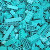 A pile of teal and light blue building blocks for creative DIY projects.
