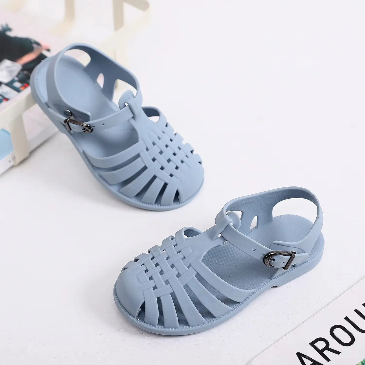 Light blue girls' gladiator jelly sandals with woven straps and non-slip sole
