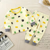 A yellow kids' cartoon cotton pajama set with long sleeves and pants featuring green, yellow, and black animal patterns.