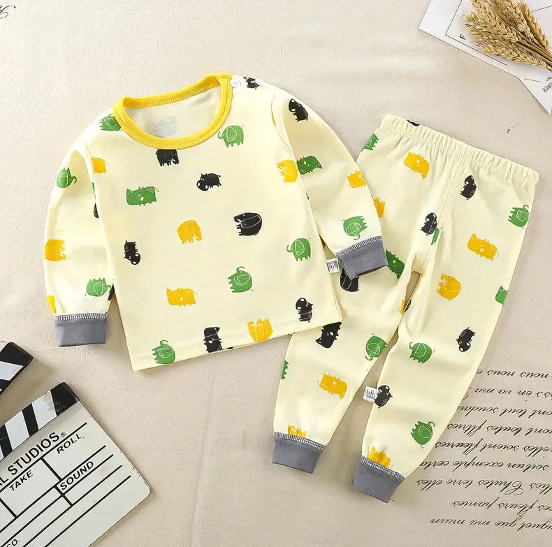 A yellow kids' cartoon cotton pajama set with long sleeves and pants featuring green, yellow, and black animal patterns.