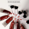 Various shades of black and dark red mirror lip glaze products are displayed on a white background.