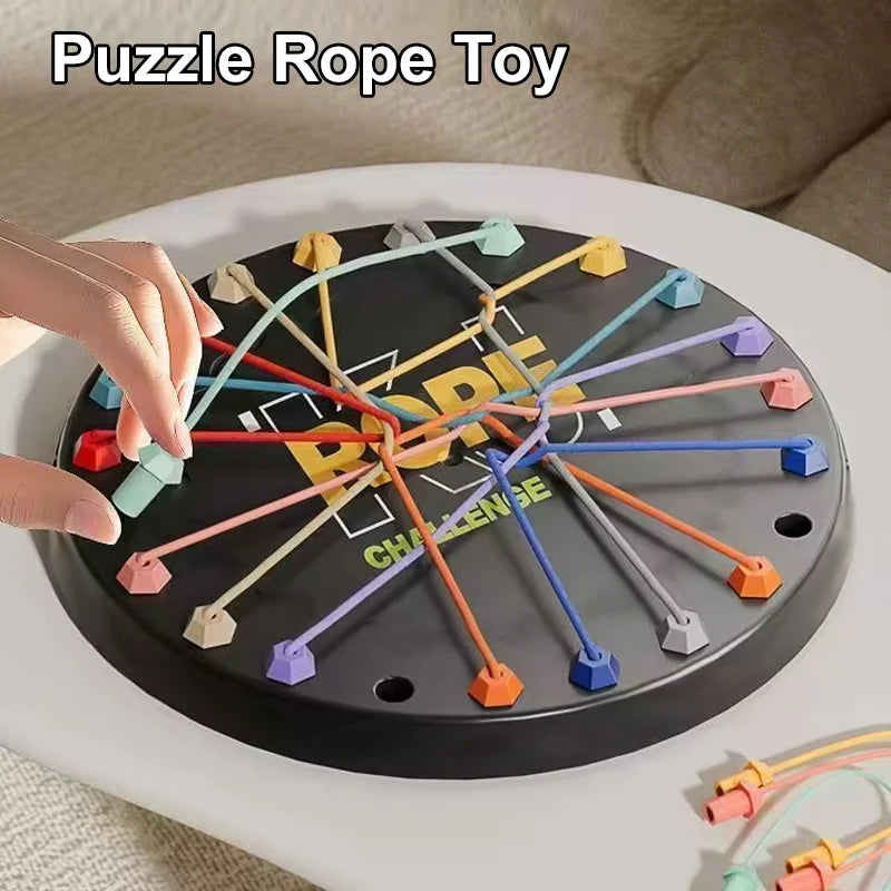 A black puzzle rope toy with colorful ropes arranged in a star pattern on a white table.