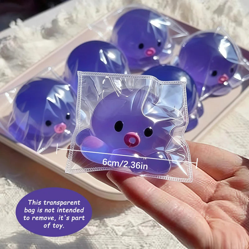 A clear plastic bag containing a purple squishy bubble squid stress relief toy is held in a hand.