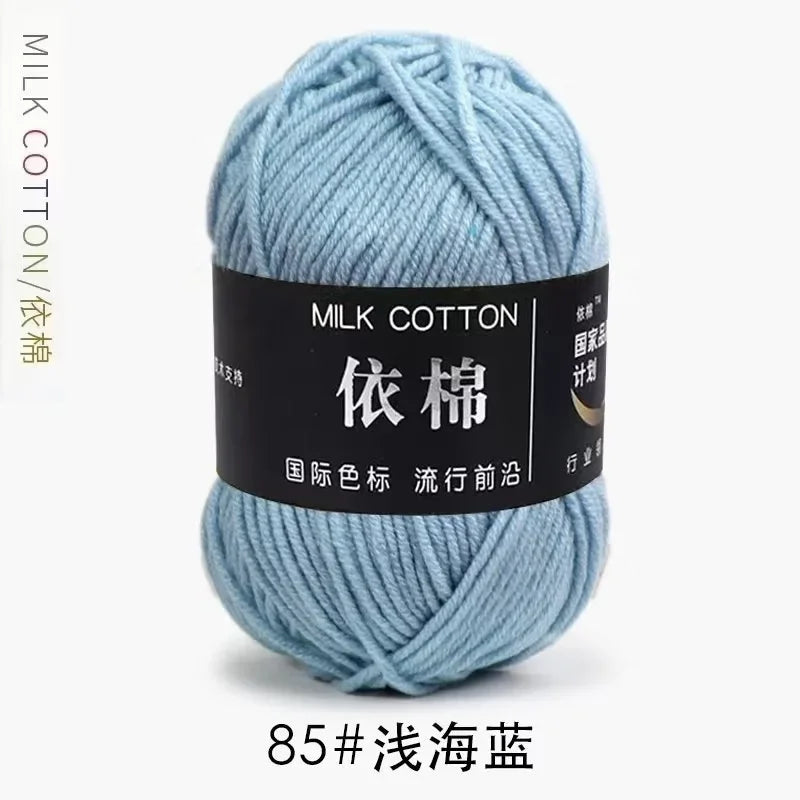A ball of light blue milk cotton yarn labeled with Chinese characters and a product number.