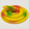 A realistic rubber snake toy with yellow, green, and red coloring coiled on a white background.