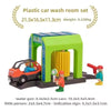A plastic car wash room set featuring a green structure and various accessories like a water gun and small figures.