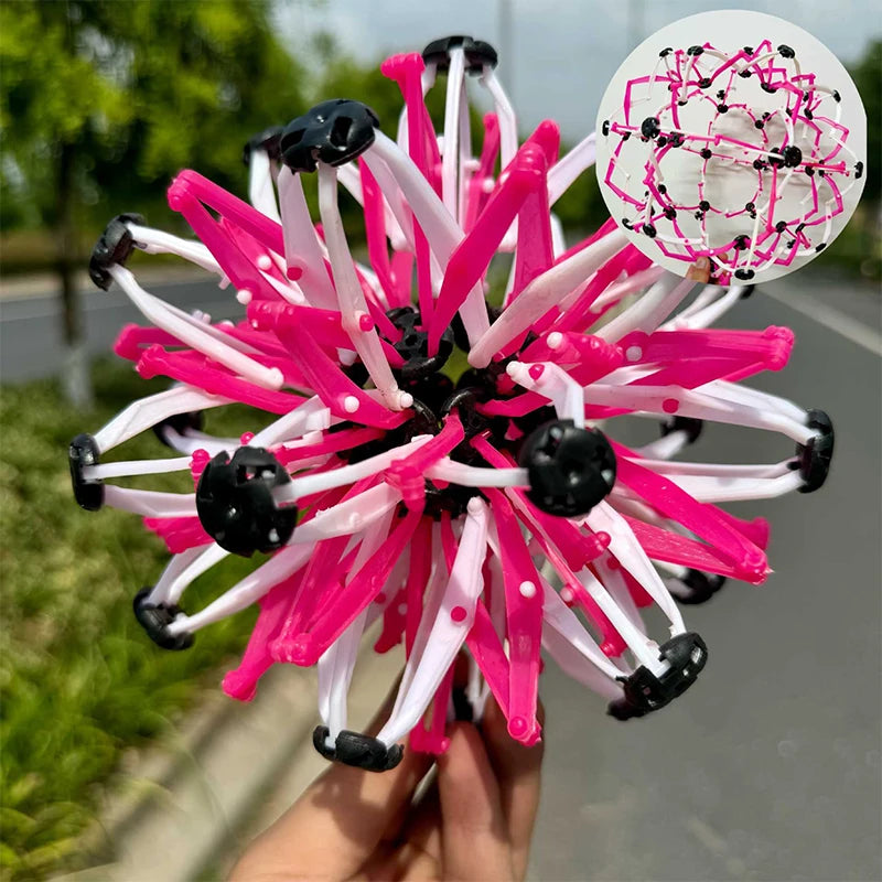 A vibrant pink and white expandable magic ball toy used for stress relief and breathing exercises.